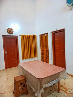 a room with two doors and a bed in it at Centre Home Homestay Wayanad in Kalpetta