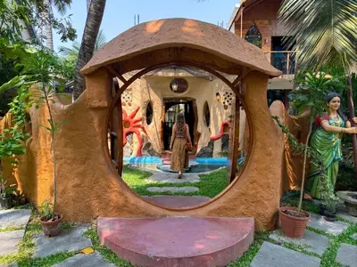 a house shaped like a tree with a woman in a mirror at Udaya Resort in Palakkad