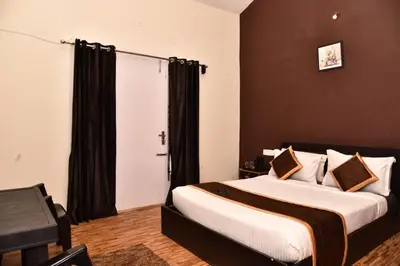 a bedroom with two beds and a window at Phoenix View Stay Ooty in Ooty