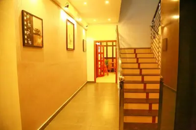 a hallway with a staircase in a house at AKAN HOTEL AND RESIDENCE in Wayanad