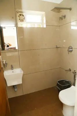 a bathroom with a toilet and a sink at Shoreline in Kozhikode