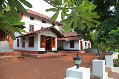 a white house with a street light in front of it at Vilayara Heritage Retreat in Kunnamangalam