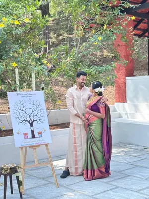 a man and a woman standing next to a sign at Vilayara Heritage Retreat in Kunnamangalam