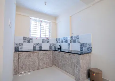 a kitchen with a sink and a counter top at Elegance Serviced Apartment in Mysore