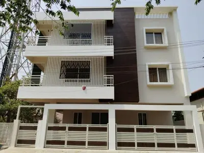 a tall white building with balconies on it at ORCHID ELITE BRINDAVAN in Mysore