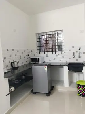 a kitchen with a counter and a sink in it at ORCHID ELITE BRINDAVAN in Mysore