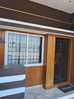 a room with two windows and a door at Royal homes a2 in Kushālnagar