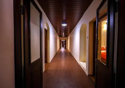 an empty hallway in a building with a wooden ceiling at Lauriston Ooty Town Heritage Bungalow by VOYE HOMES in Ooty