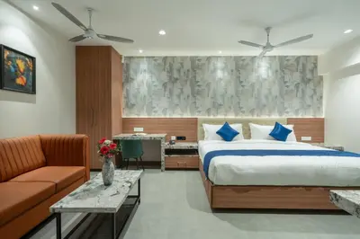 a bedroom with a bed and a couch at J Square Inn in Coimbatore