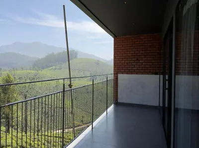 a balcony with a view of the mountains at WINTEL WILD in Vālpārai
