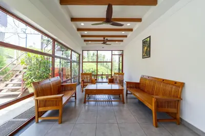 a dining room with wooden chairs and a table at WINTEL WILD in Vālpārai