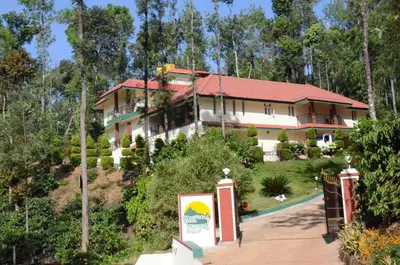 a house on a hill with a sign in front of it at Ibbanicadu Estate Homestay in Madikeri