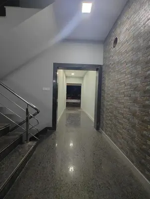 an empty hallway with a brick wall and stairs at JP Residency, near to Isha, Adhiyogi & Karunya in Alāndurai
