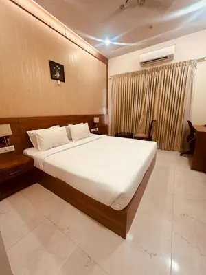 a bedroom with a large bed in a room at Fortune Hills in Palakkad