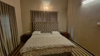 a bedroom with a bed in a room at Diya's Estate Stay in Thamarassery