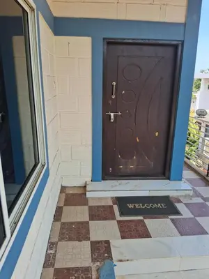 a wooden door on the side of a house at Royal homes a5 in Kushālnagar
