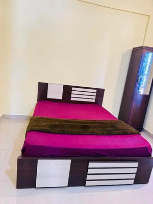 a bedroom with a large bed with pink sheets at Rivera Holiday Home in Vythiri