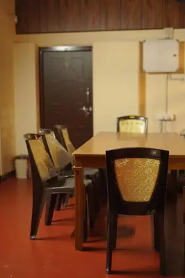 a dining room with a table and chairs at Greene Villa in Palakkad