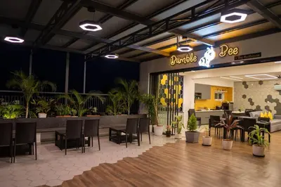 a restaurant with a table and chairs and plants at Bumblebee - The Penthouse in Mysore