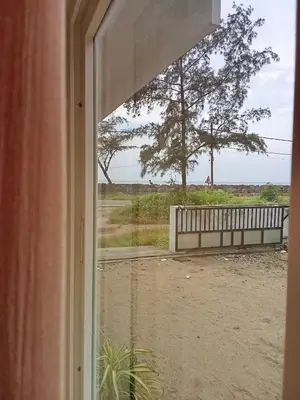 a window view of the beach from a house at Appu's Nido in Pallipuram