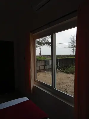 a window in a room with a view of a yard at Appu's Nido in Pallipuram