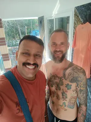 two men standing next to each other with their tattoos at Coastal Den Homestay in Pallipuram
