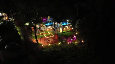 an aerial view of a house at night with lights at Mannath Private Pool Villas at Vellarimala in Wayanad