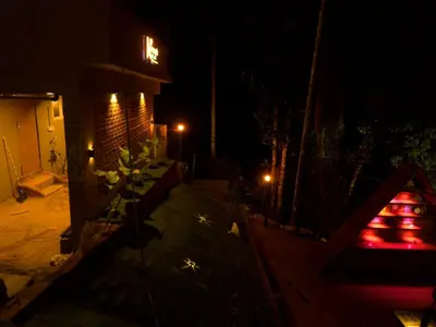 a view of a patio at night with lights at Mannath Private Pool Villas at Vellarimala in Wayanad
