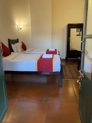 a bedroom with a large bed in a room at Lakefront Home Hotel in Ooty