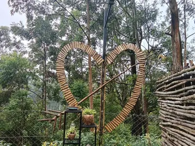 a sculpture of a heart next to a fence at IInfinity Kodaikanal in Kūkkāl