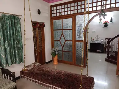 a living room with a couch and a swing at Unwind @ Serene Retreat in Palakkad