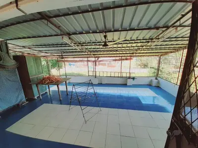 a room with a blue floor and a table at Unwind @ Serene Retreat in Palakkad