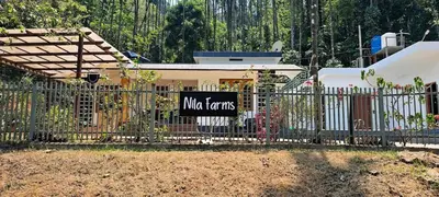 a sign on a fence in front of a house at Nila Farms - Farm stay with a unique swimming Pool in Attappādi