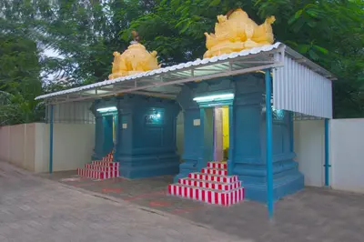 a small building with two statues on top of it at ThulasiRams Service Apartments in Coimbatore