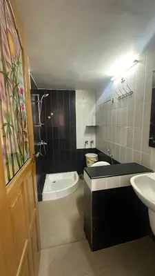a bathroom with a sink and a toilet and a tub at Amarah Homestay in Ooty