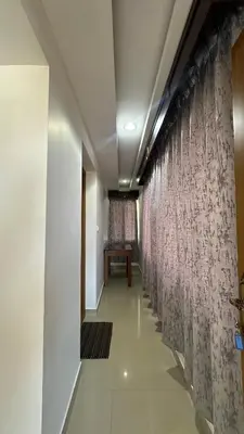 a long hallway with curtains on the walls at Amarah Homestay in Ooty