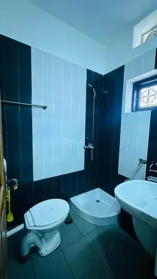 a bathroom with a toilet and a sink at Amarah Homestay in Ooty