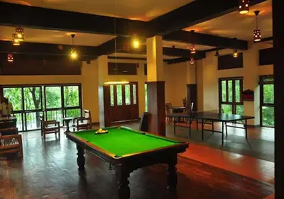 a large room with a green pool table in it at Wayanad Silverwoods Forest Resort & Spa in Padinjarathara