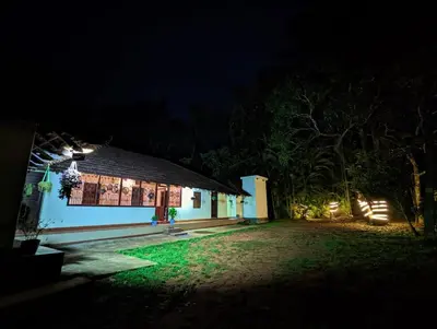 a house at night with lights on it at Winter Villa Karapuzha in Wayanad