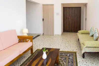 a living room with a couch and a table at Maya Homez - Coimbatore in Coimbatore