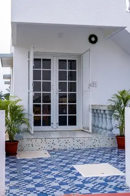 a house with a blue and white tile floor at Maya Homez - Coimbatore in Coimbatore
