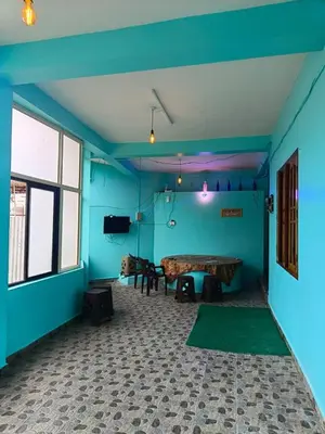 a room with blue walls and a table in it at Pavithra cottage munnar in Munnar