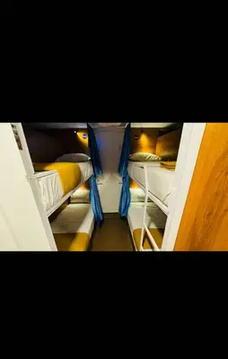 a group of bunk beds in a room at LOWFARE HOTELS in Kozhikode