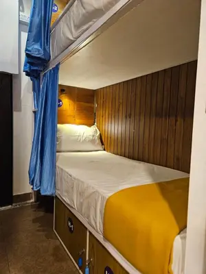 a bedroom with two bunk beds on a boat at LOWFARE HOTELS in Kozhikode