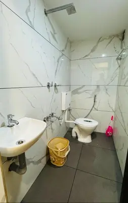 a bathroom with a sink and a toilet at LOWFARE HOTELS in Kozhikode