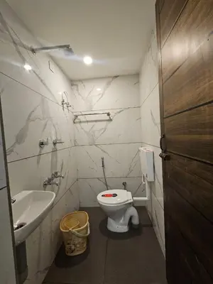 a small bathroom with a toilet and a sink at LOWFARE HOTELS in Kozhikode