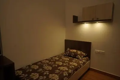 a small bedroom with a bed with a blanket at Home stay - Near Cochin Airport in Angamali