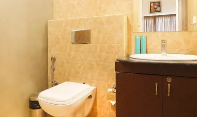 a bathroom with a toilet and a sink at Treebo Skydale Inn & Suites With Mountain View in Ooty