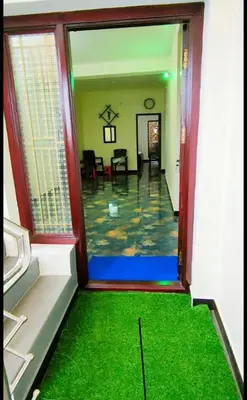 a room with a view of a room with green grass at Arulmozhi Dream in Ooty