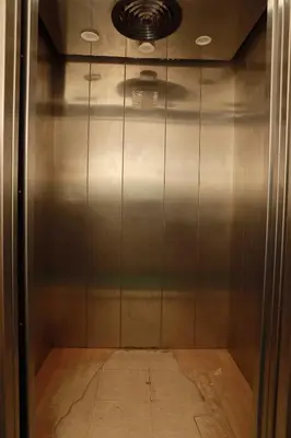a elevator in a building with a metal wall at KG Grand Inn in Erode